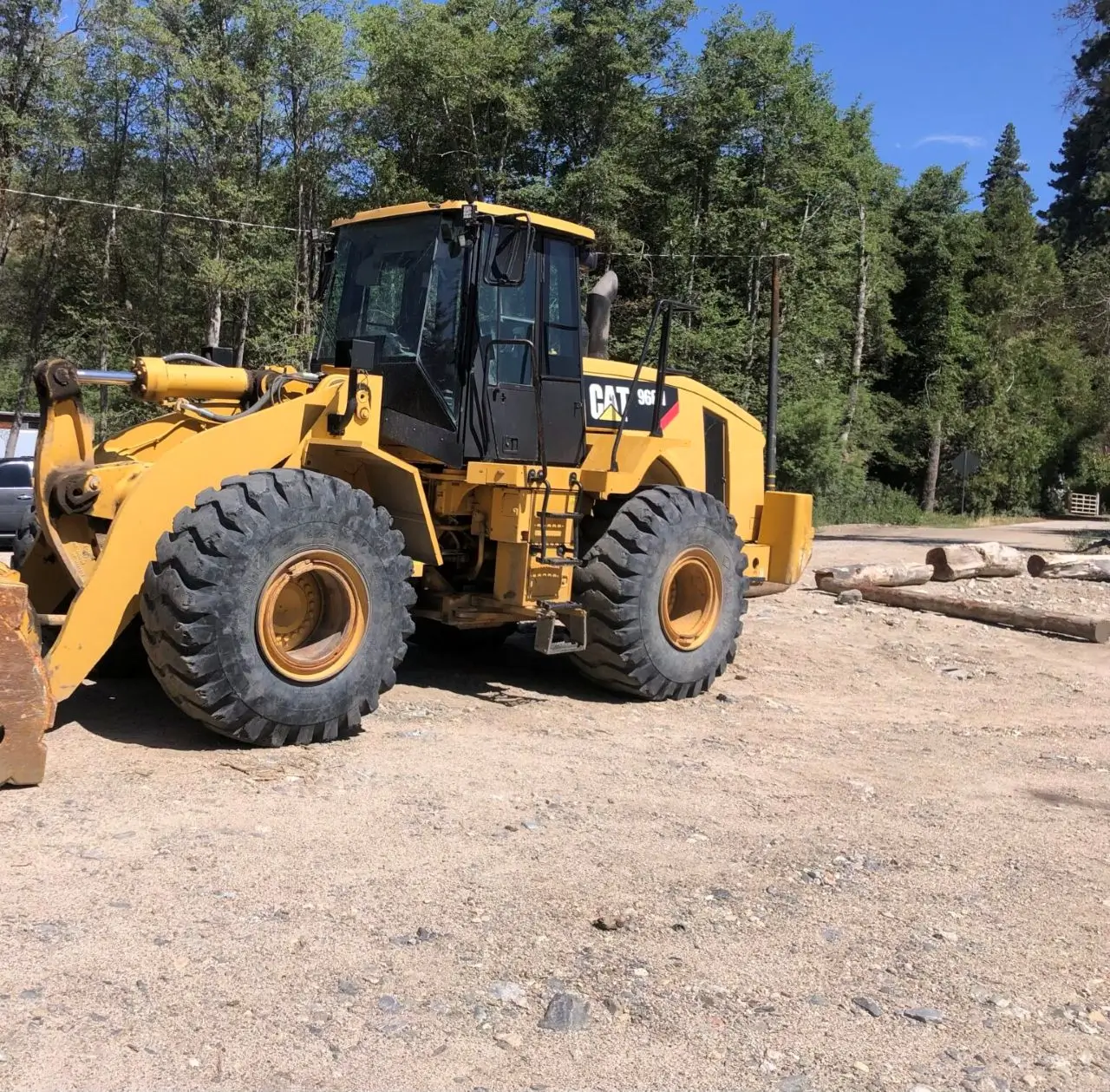 A yellow and black tractor is parked on the ground